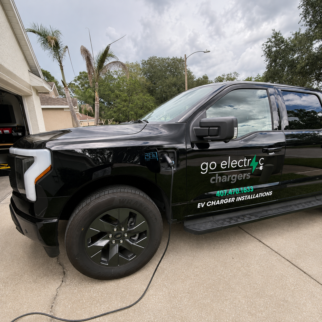 Go Electric Chargers branded electric service truck charging at a Florida home